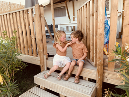 Kindjes op de veranda van de glamping tent van Villa Alwin Beach Resort